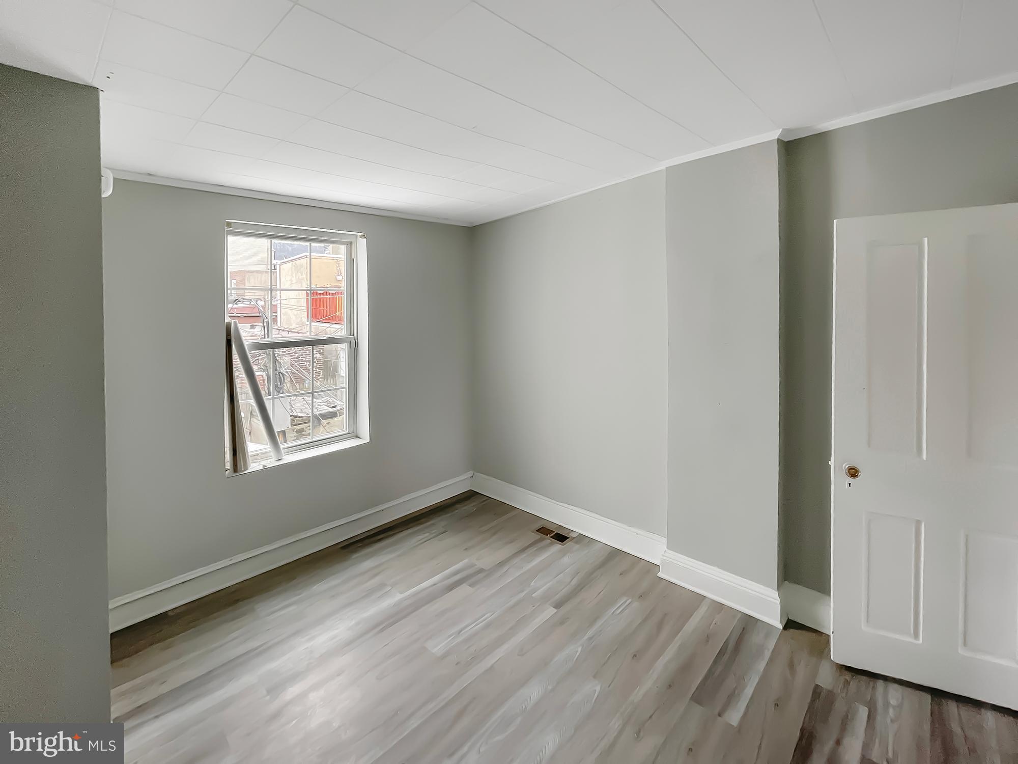 160 McClellan Street Philadelphia, PA 19148 - Photo 5 of 29 an empty room with wooden floor and windows