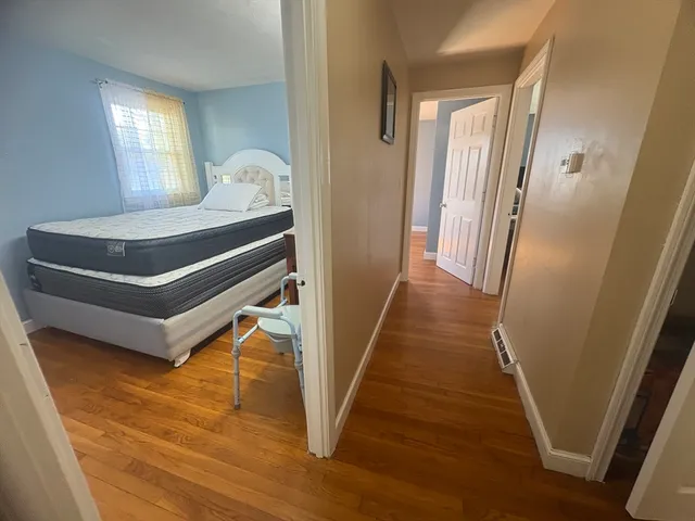 a view of entryway and hall with wooden floor