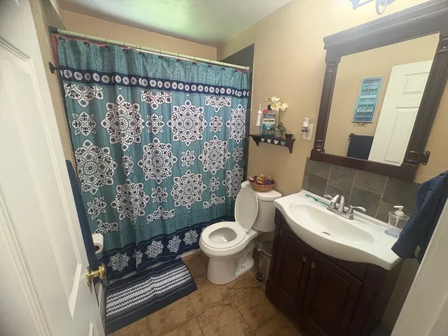 a bathroom with a sink toilet and shower