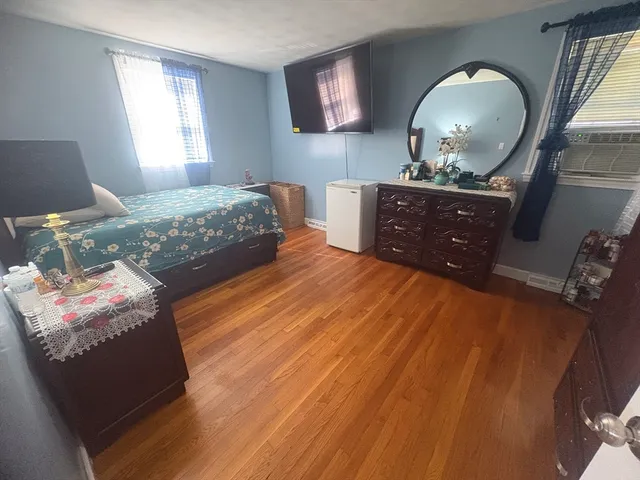 a bedroom with a bed and a mirror