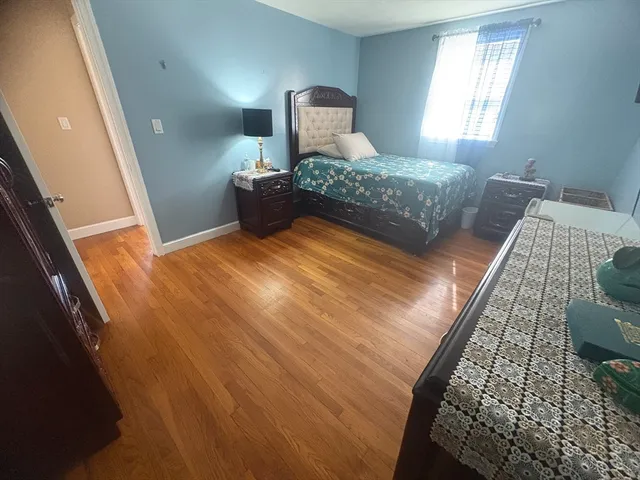 a bedroom with a bed lamp and window