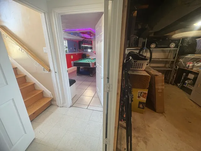 a room with pool table and windows