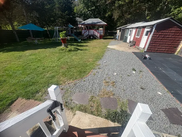 a view of a wooden house with a yard