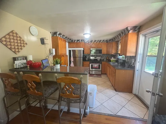 a dining room with furniture and a floor to ceiling window