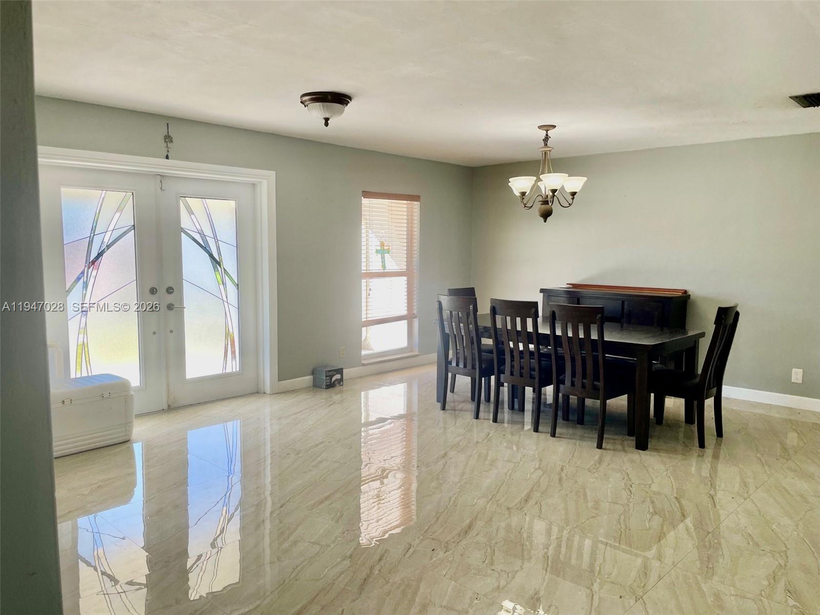14503 Southwest 84th Street Miami, FL 33143 - Photo 3 of 23 a view of a dining room with furniture and chandelier