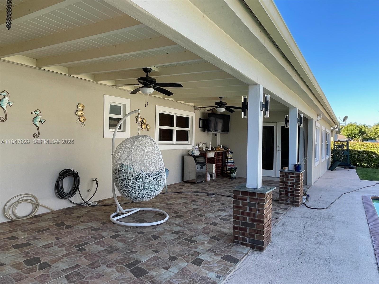 14503 Southwest 84th Street Miami, FL 33143 - Photo 5 of 23 a living room with furniture a window and gym equipment