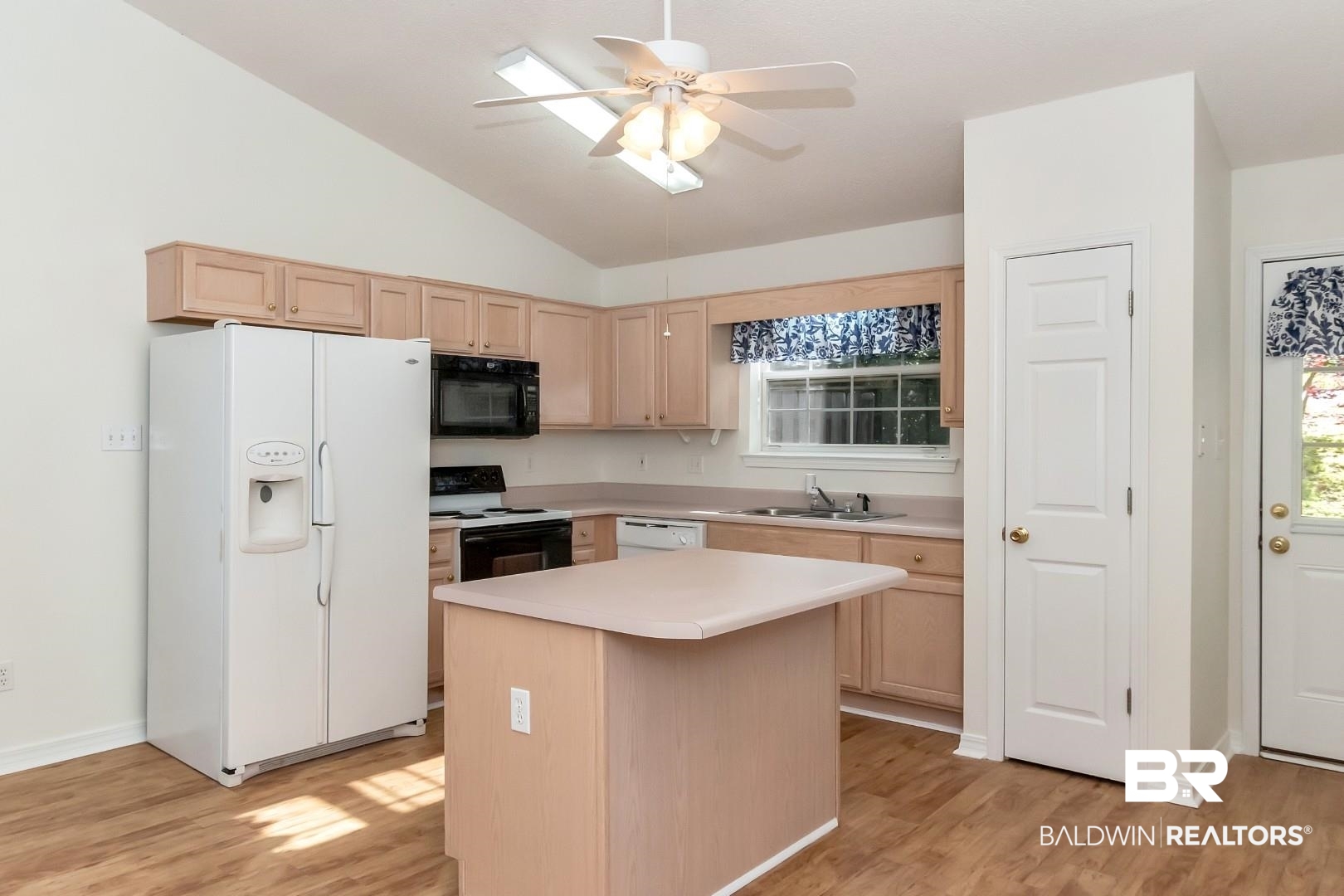672 Spring Lake Drive East Mobile, AL 36695 - Photo 19 of 26 Kitchen with a sink, black appliances, light wood-type flooring, and light brown cabinetry