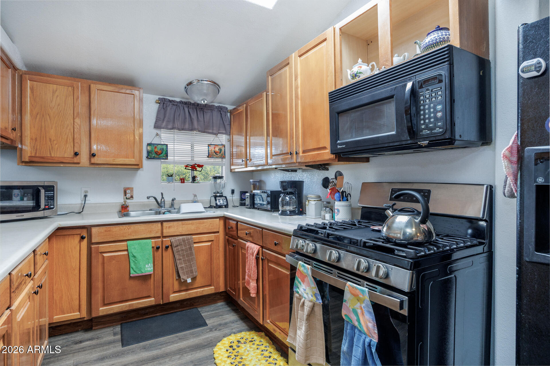 6185 East Monitor Street Picacho, AZ 85141 - Photo 47 of 55 a kitchen with stainless steel appliances granite countertop a stove a sink and a microwave