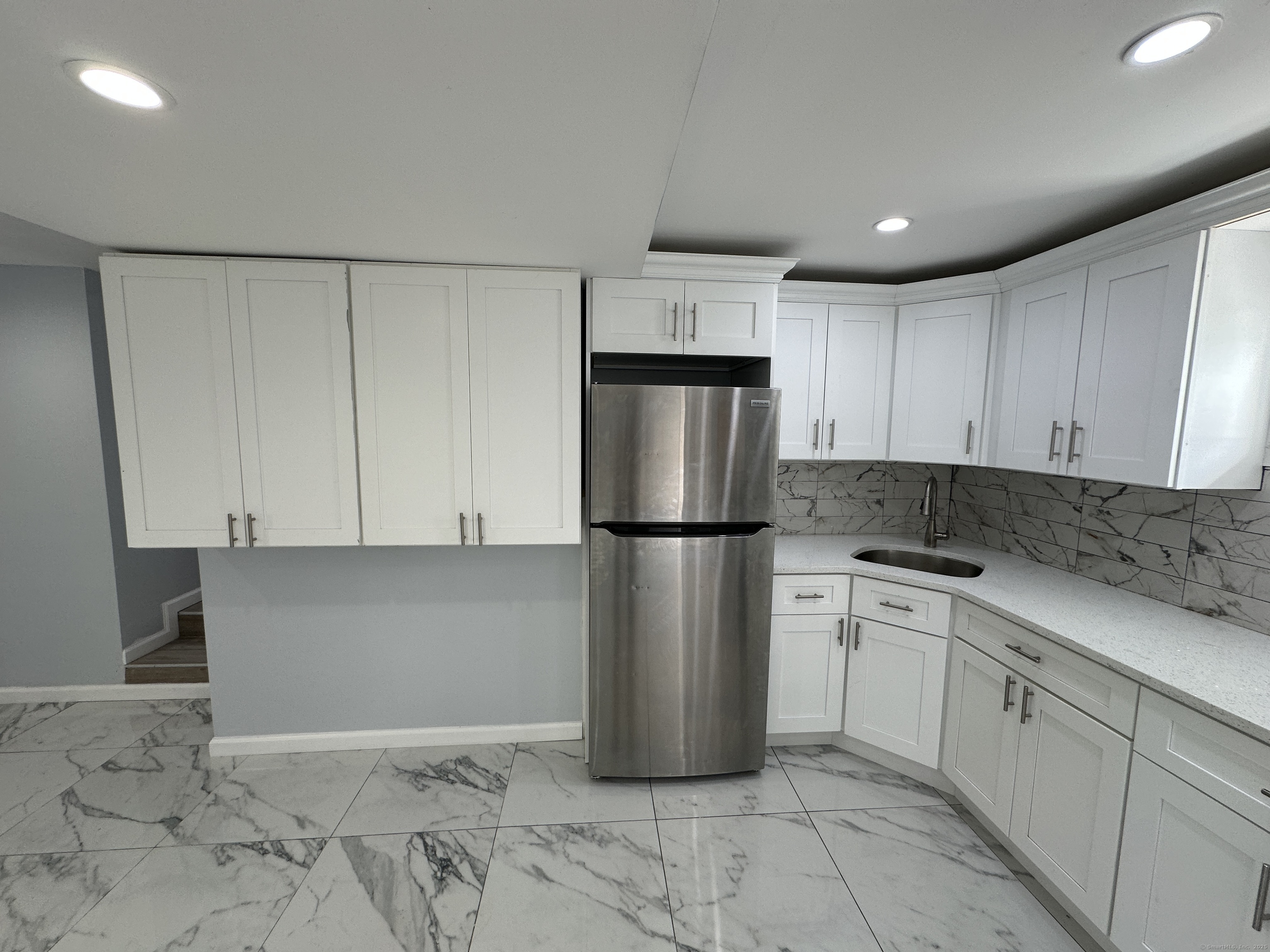 48 Prest Street New London, CT 06320 - Photo 12 of 27 a kitchen with a refrigerator sink and cabinets