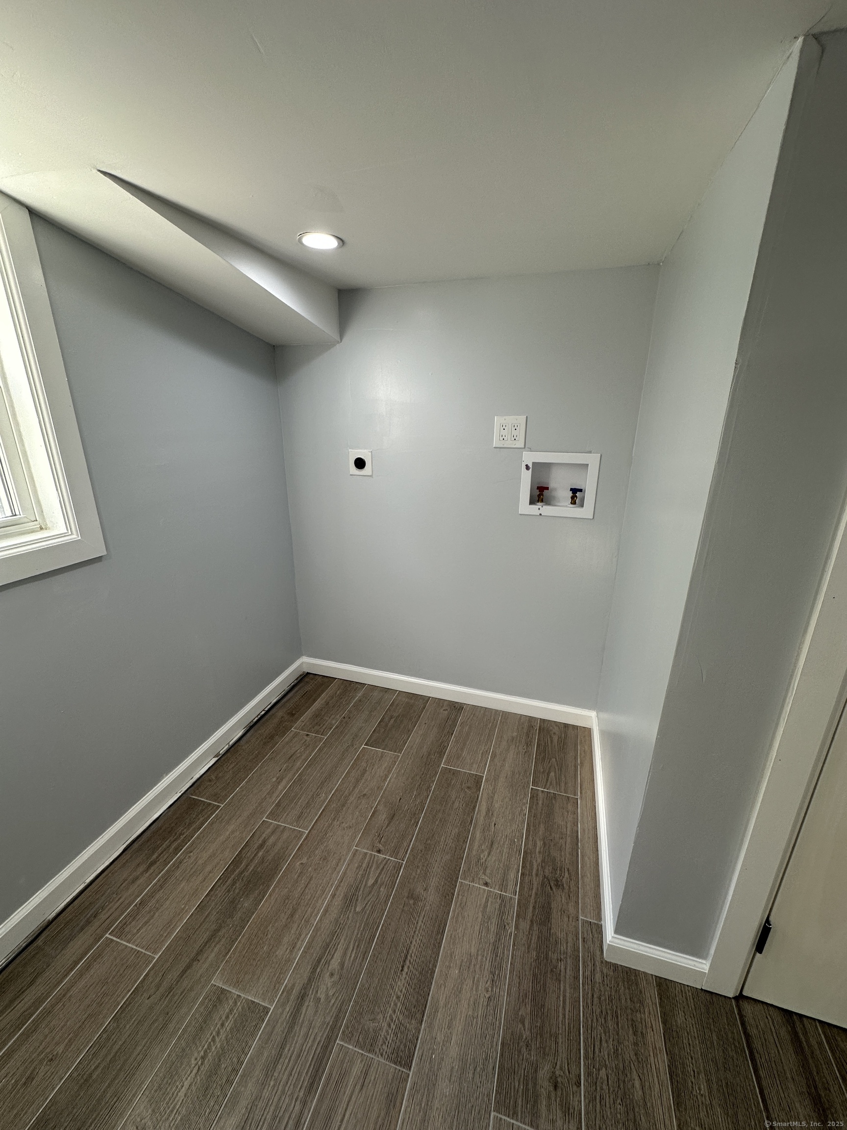 48 Prest Street New London, CT 06320 - Photo 19 of 27 an empty room with wooden floor and windows