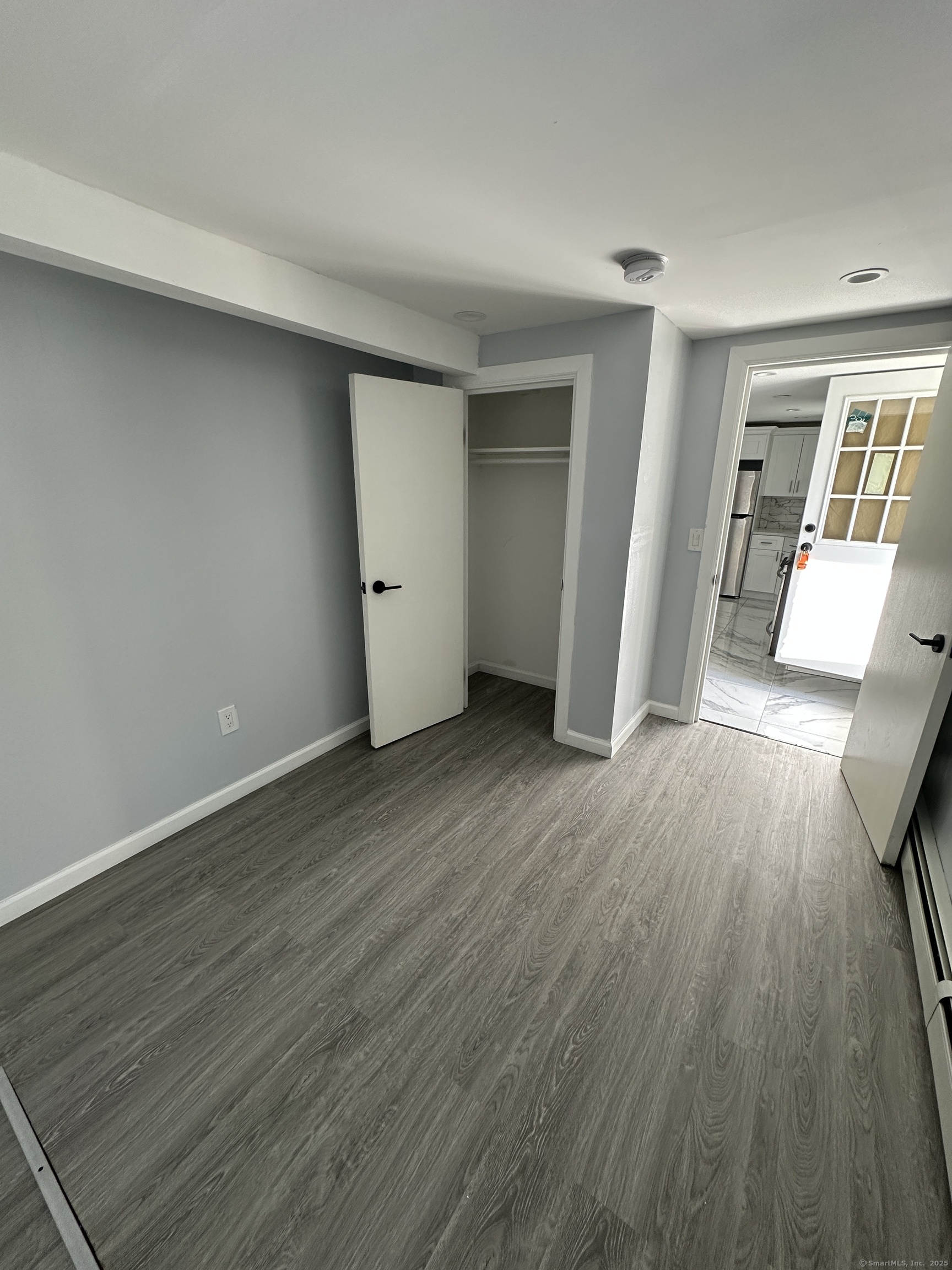 48 Prest Street New London, CT 06320 - Photo 2 of 27 an empty room with wooden floor and windows