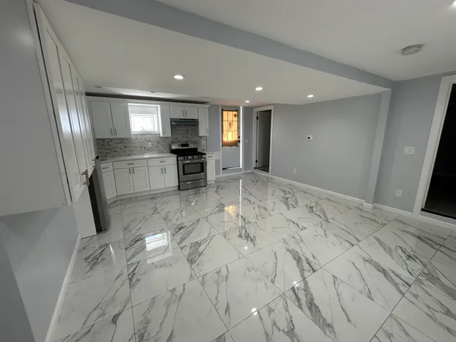 a front view of a house with a garden and garage