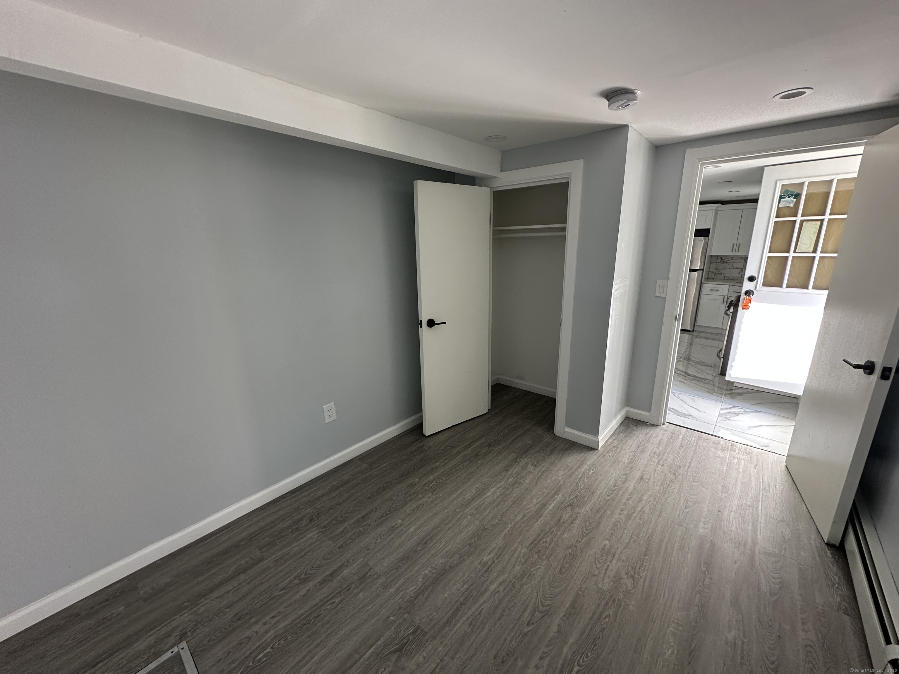 48 Prest Street New London, CT 06320 - Photo 3 of 27 an empty room with wooden floor and windows