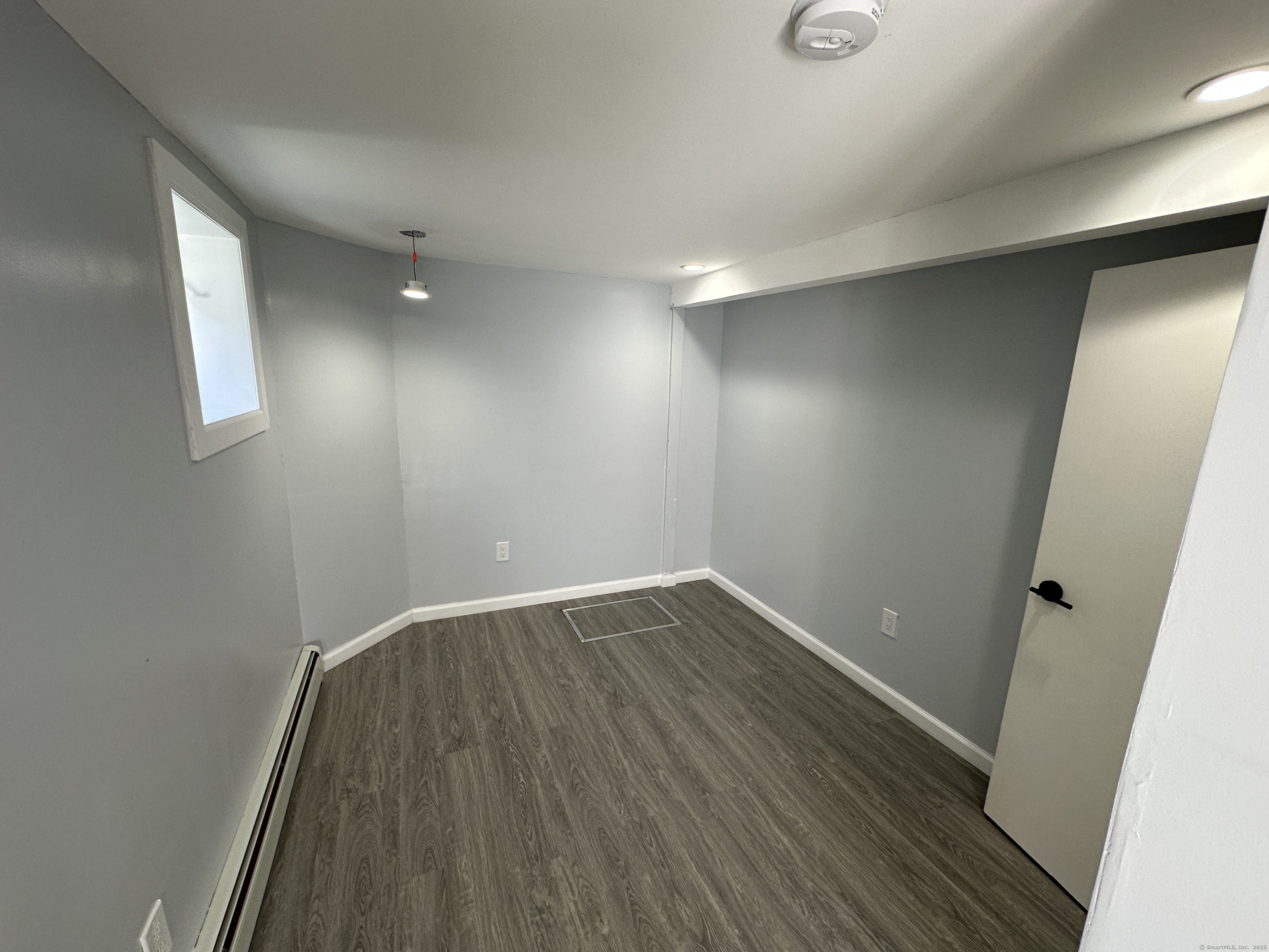 48 Prest Street New London, CT 06320 - Photo 4 of 27 an empty room with wooden floor and windows