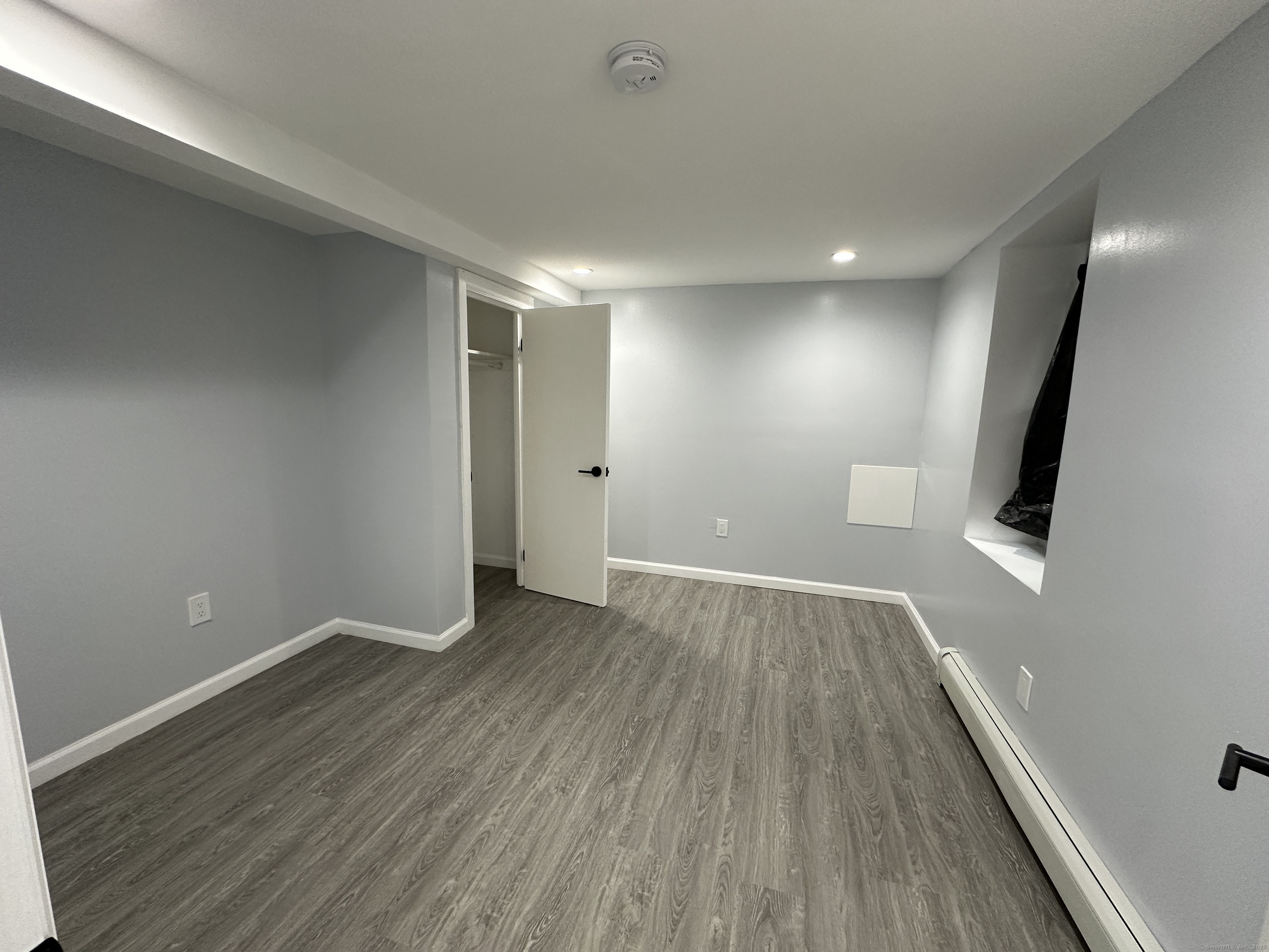 48 Prest Street New London, CT 06320 - Photo 6 of 27 an empty room with wooden floor and windows