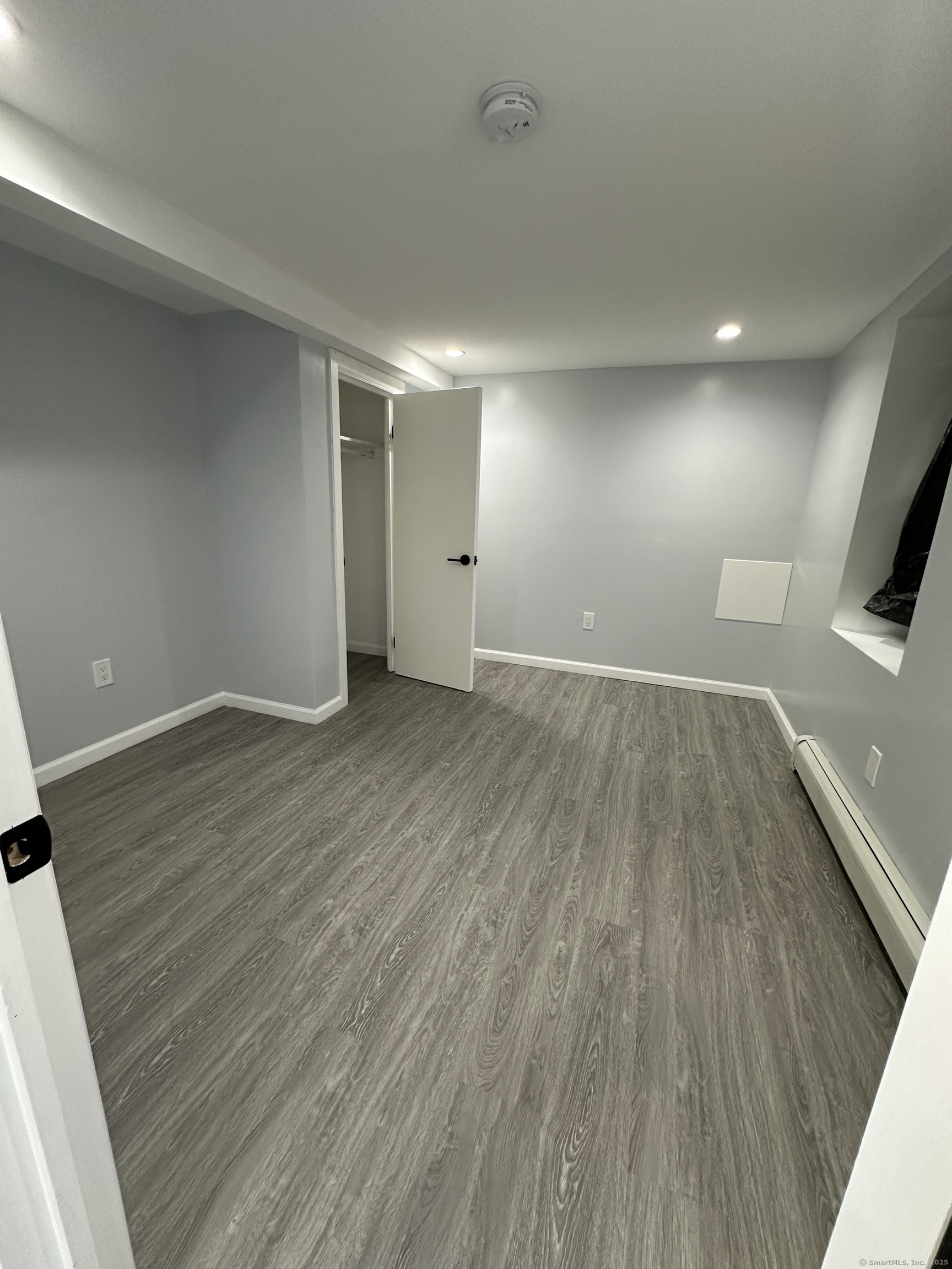 48 Prest Street New London, CT 06320 - Photo 7 of 27 an empty room with wooden floor and windows