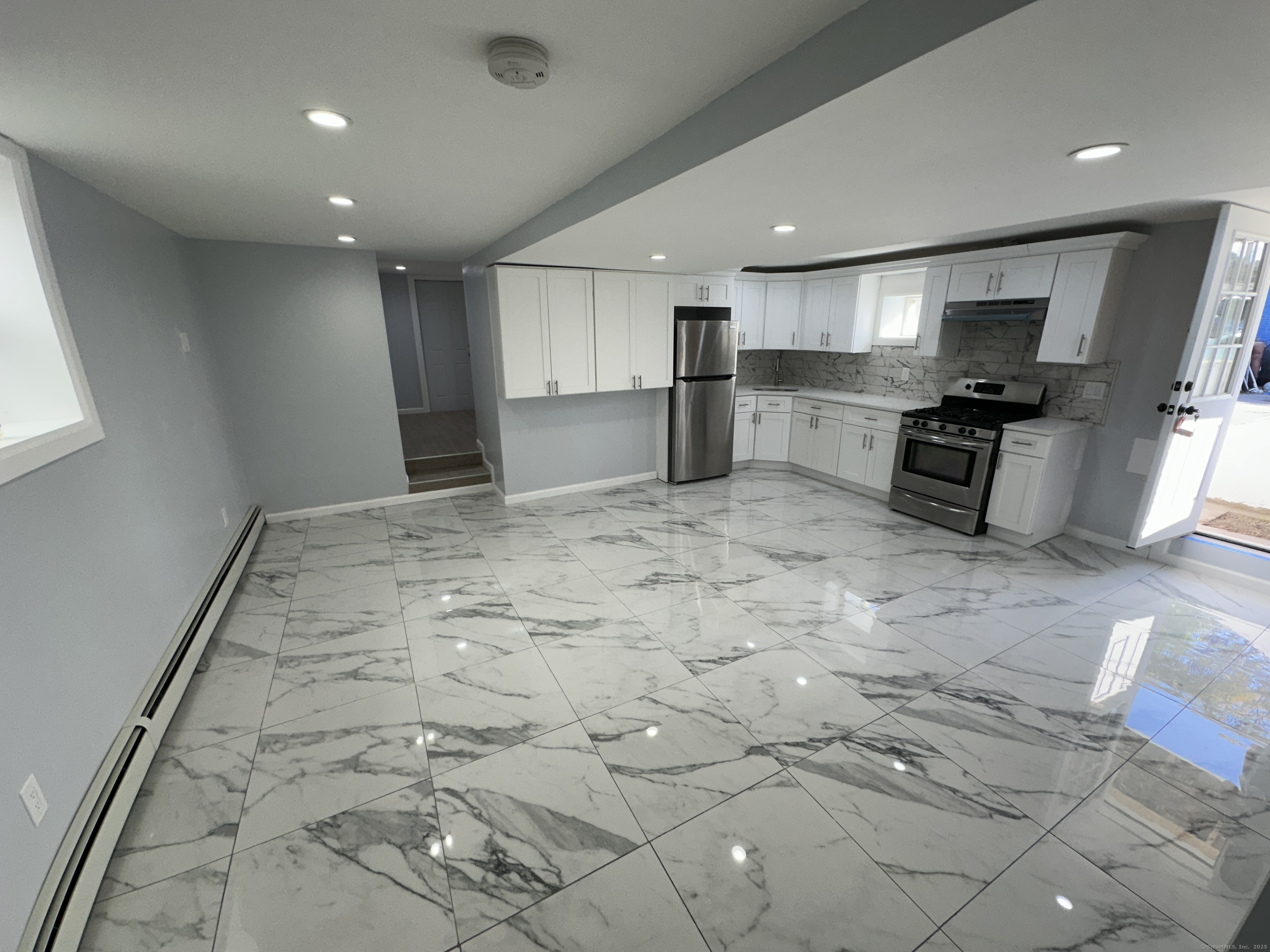 48 Prest Street New London, CT 06320 - Photo 9 of 27 a large kitchen with kitchen island a stove a sink a refrigerator and a stove top oven