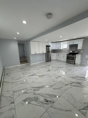 a kitchen with stainless steel appliances a refrigerator and a stove top oven