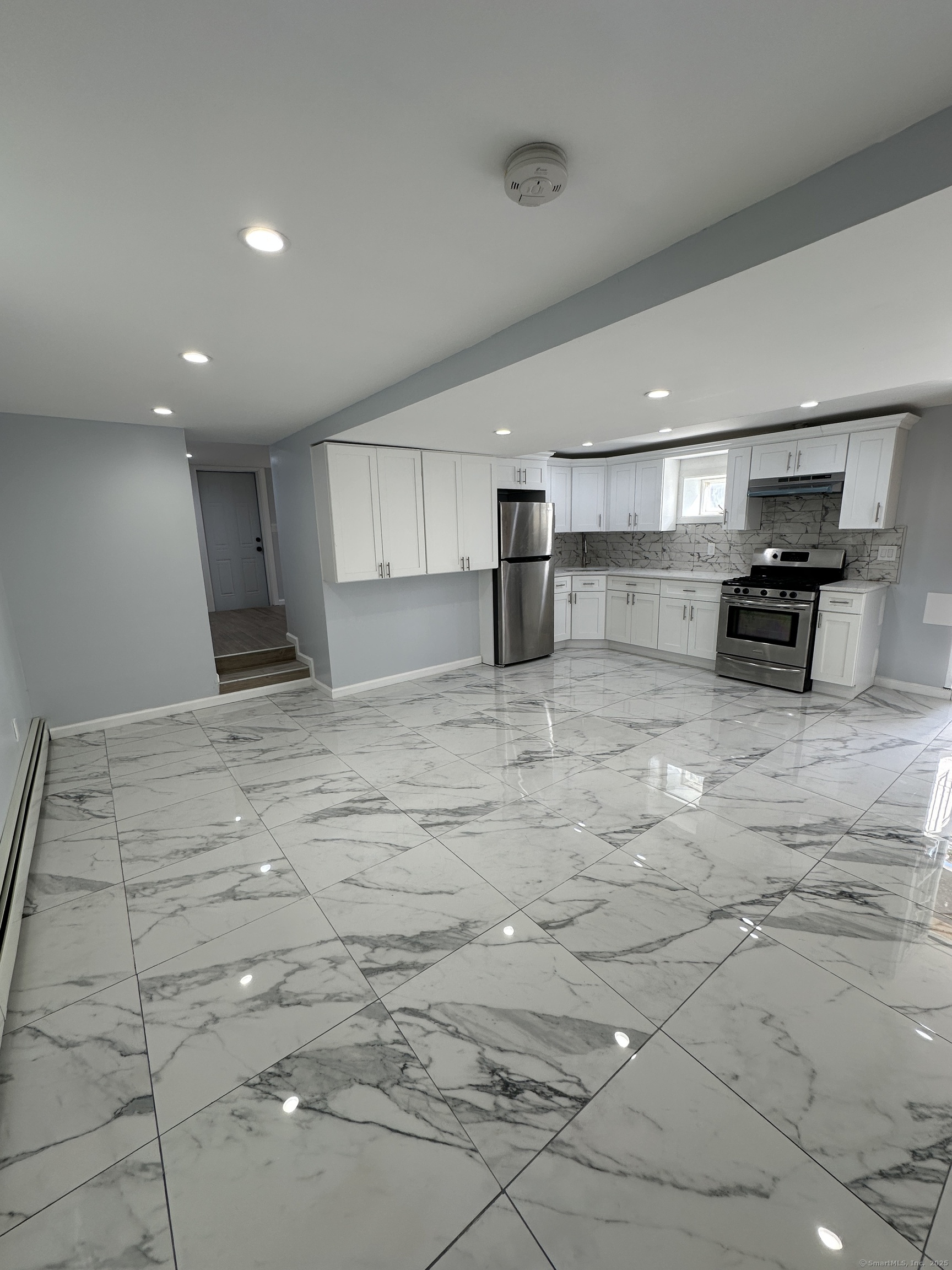 48 Prest Street New London, CT 06320 - Photo 10 of 27 a kitchen with stainless steel appliances a refrigerator and a stove top oven