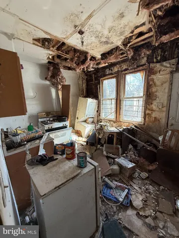 a kitchen with a stove and a wooden floor