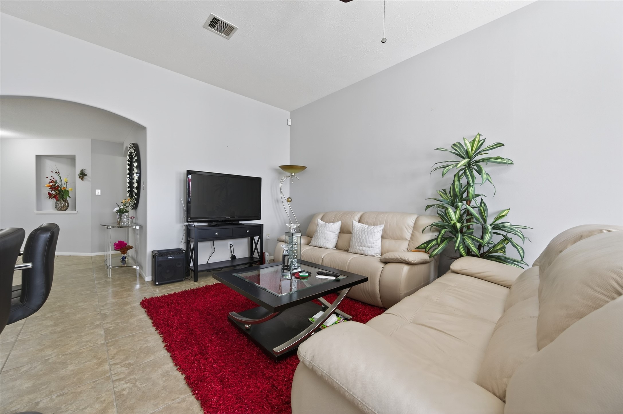 19655 Perth Meadows Court Katy, TX 77449 - Photo 16 of 44 a living room with furniture a flat screen tv and a potted plant