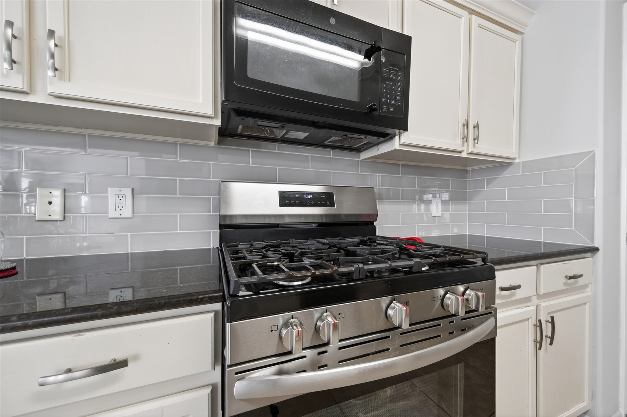 19655 Perth Meadows Court Katy, TX 77449 - Photo 23 of 44 a kitchen with stainless steel appliances granite countertop white cabinets and black stove top oven with granite countertops