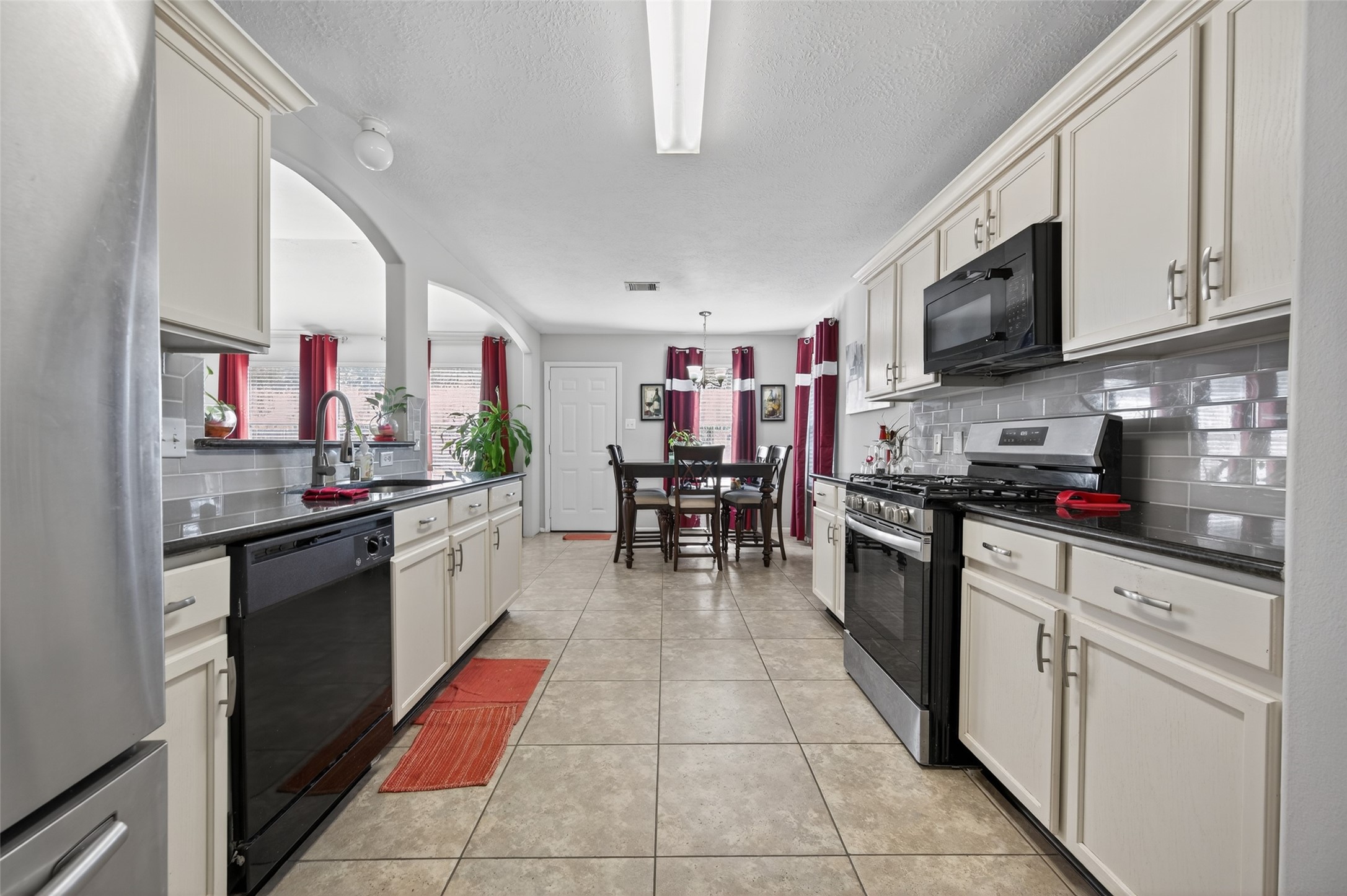 19655 Perth Meadows Court Katy, TX 77449 - Photo 25 of 44 a kitchen with stainless steel appliances granite countertop a refrigerator and a stove top oven