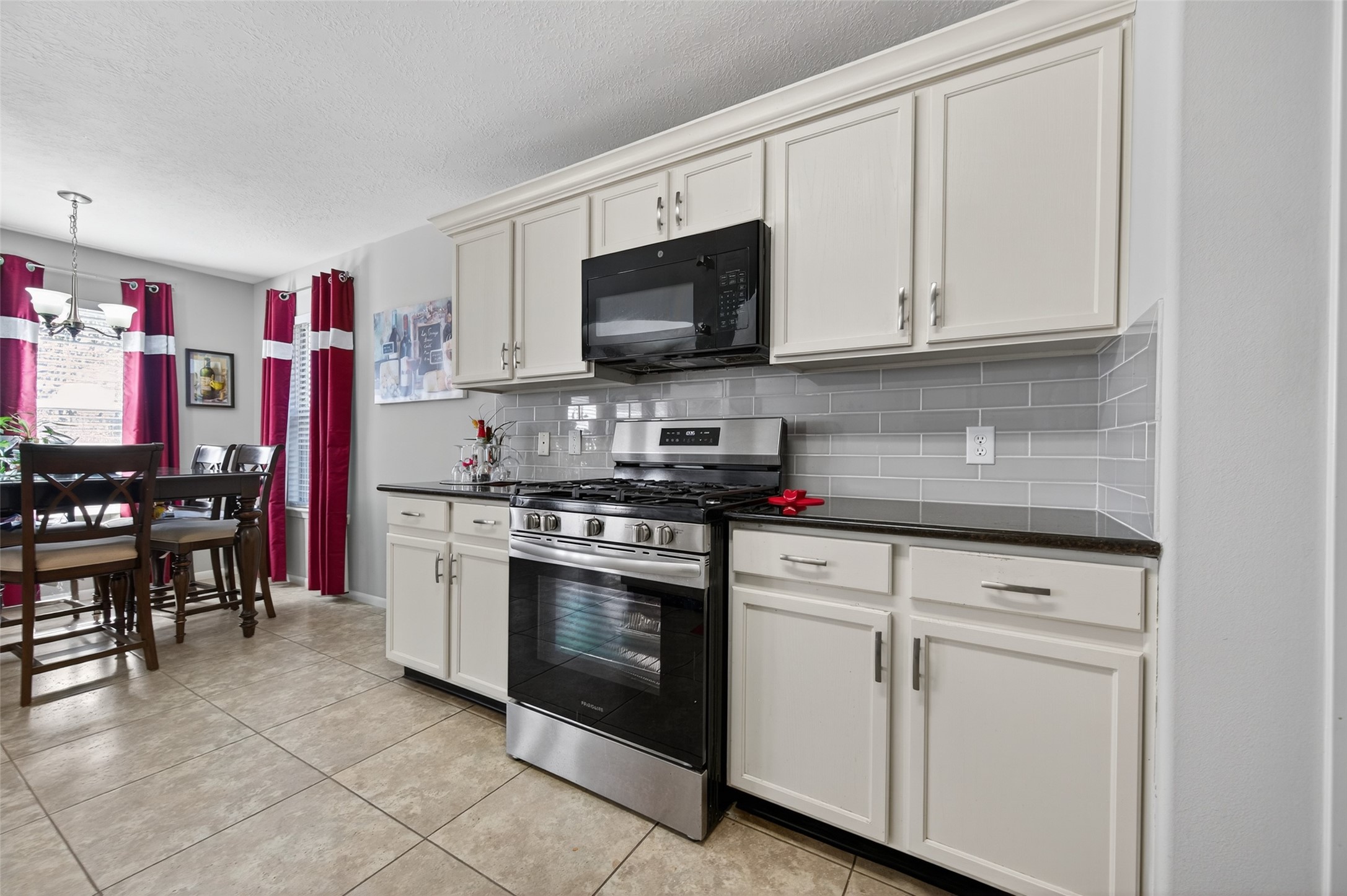 19655 Perth Meadows Court Katy, TX 77449 - Photo 26 of 44 a kitchen with stainless steel appliances granite countertop a stove a sink and a microwave