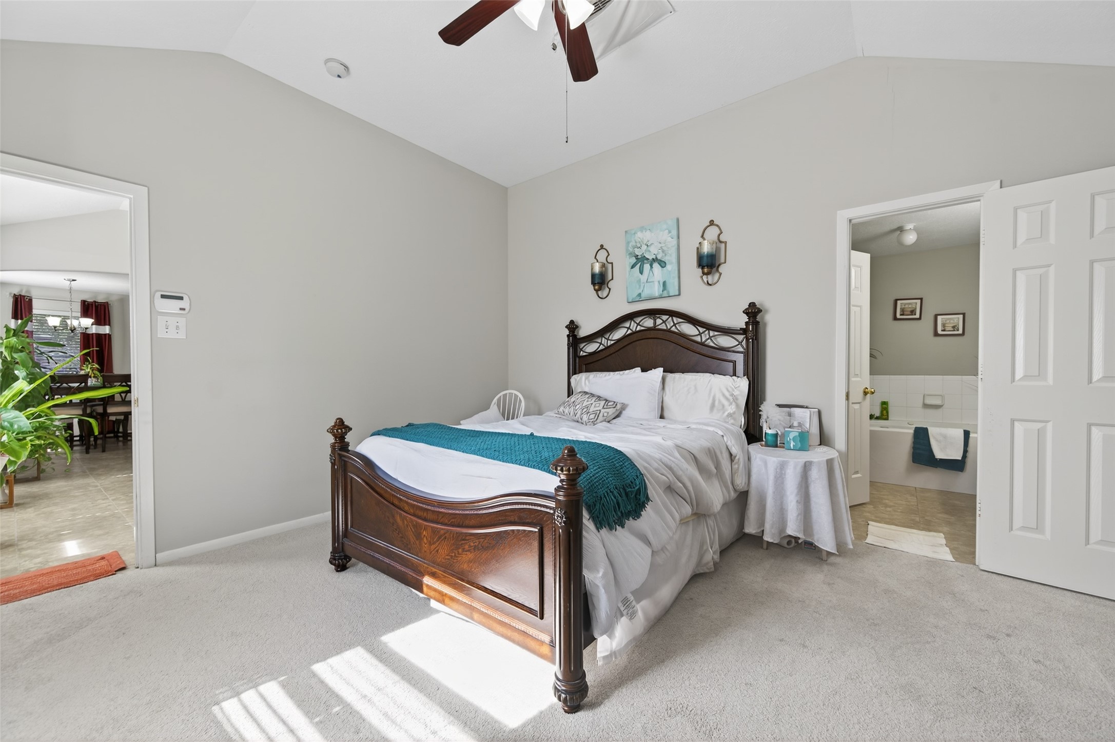 19655 Perth Meadows Court Katy, TX 77449 - Photo 33 of 44 a bedroom with a bed and a chandelier