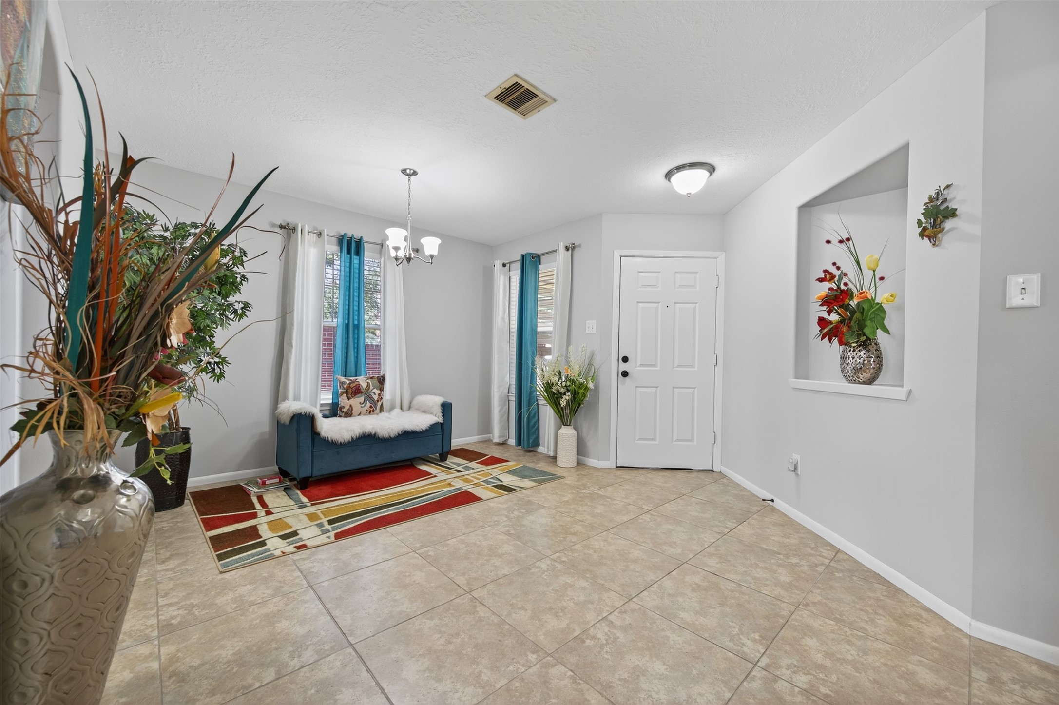 19655 Perth Meadows Court Katy, TX 77449 - Photo 10 of 44 a living room with furniture gym equipment and a chandelier