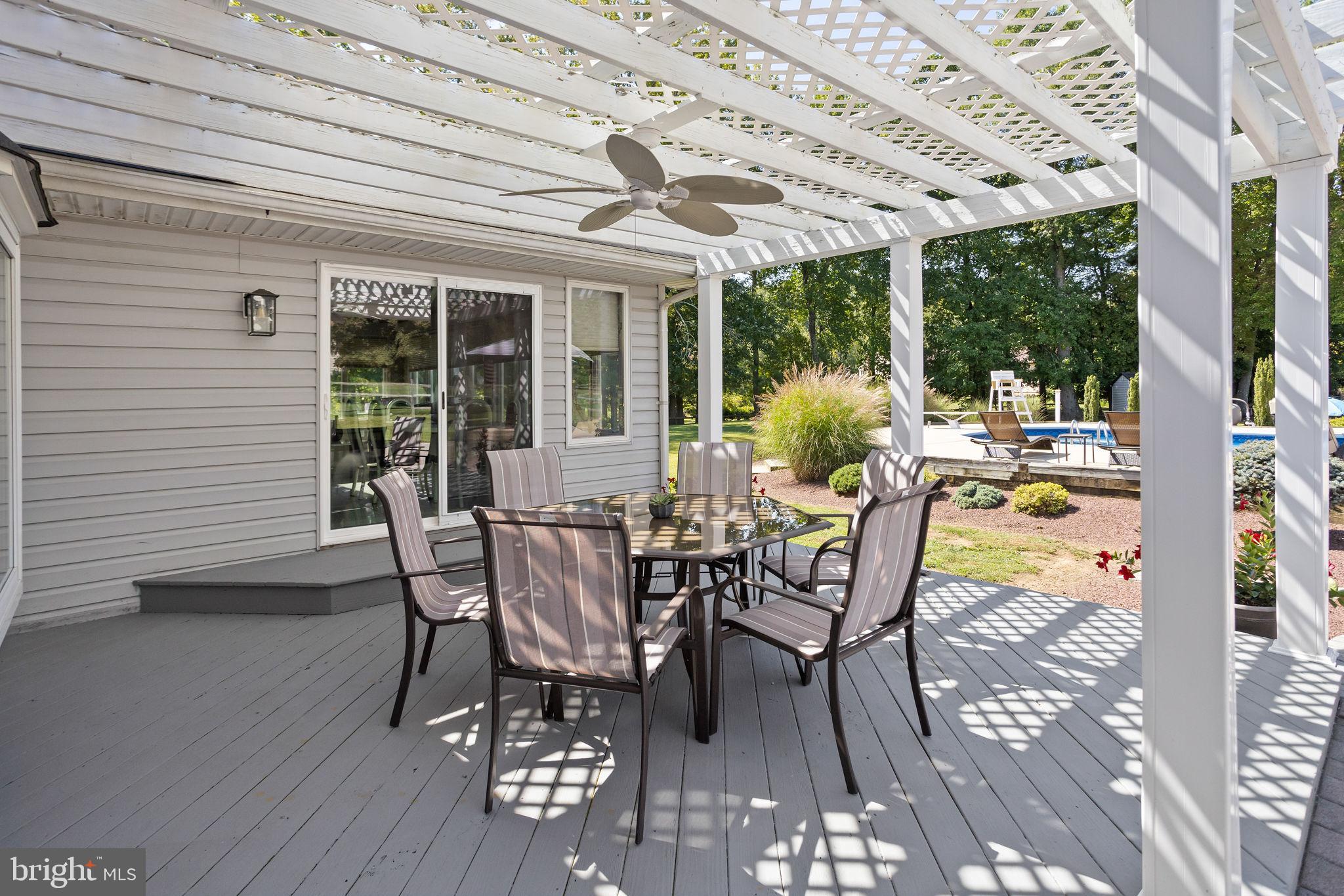 420 Extonville Road Allentown, NJ 08501 - Photo 12 of 57 a view of a patio with table and chairs next to a yard