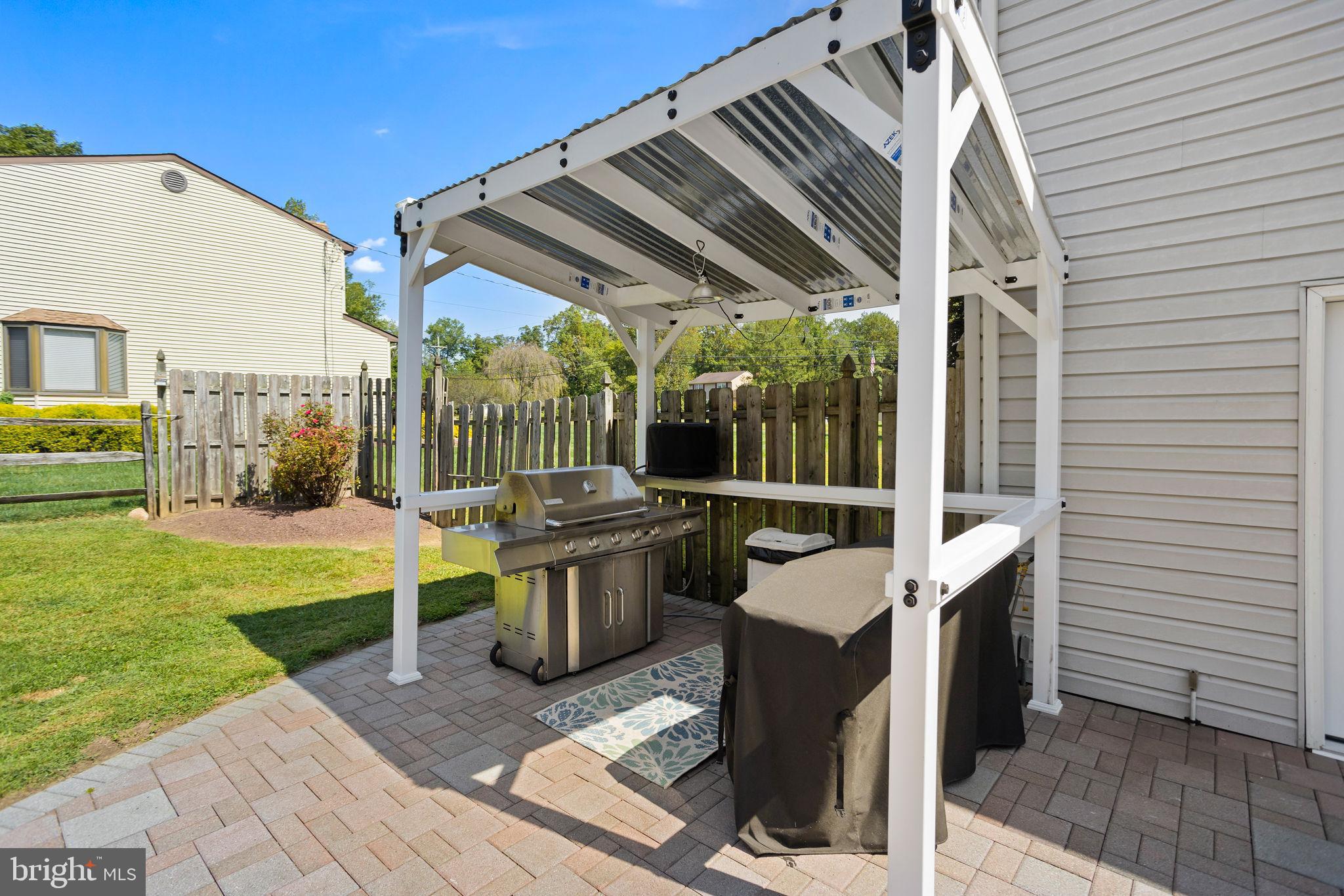 420 Extonville Road Allentown, NJ 08501 - Photo 14 of 57 a view of a patio with a table chairs and a backyard