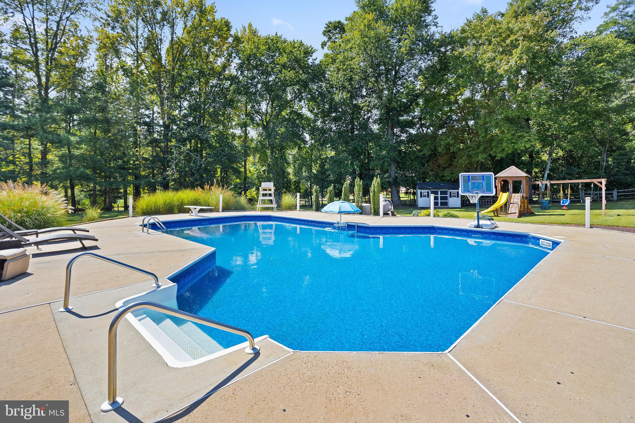 420 Extonville Road Allentown, NJ 08501 - Photo 15 of 57 a view of a swimming pool with an outdoor seating and a yard