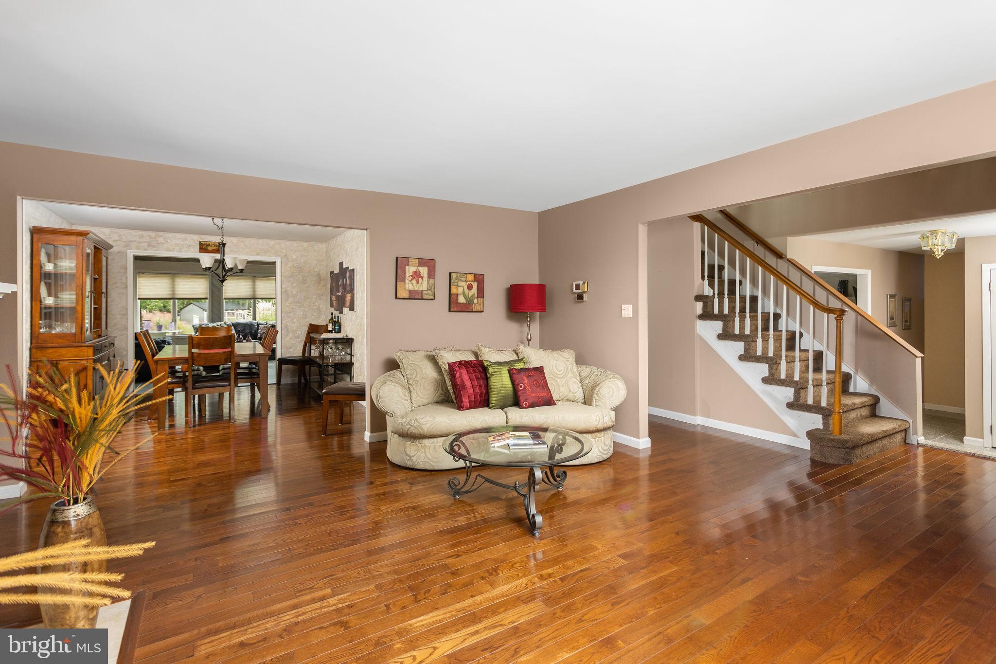 420 Extonville Road Allentown, NJ 08501 - Photo 27 of 57 a living room with furniture and a dining table with wooden floor