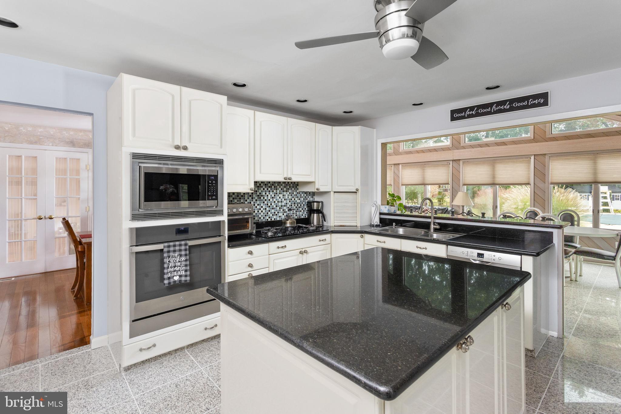 420 Extonville Road Allentown, NJ 08501 - Photo 33 of 57 a kitchen with stainless steel appliances granite countertop a sink a stove and a refrigerator