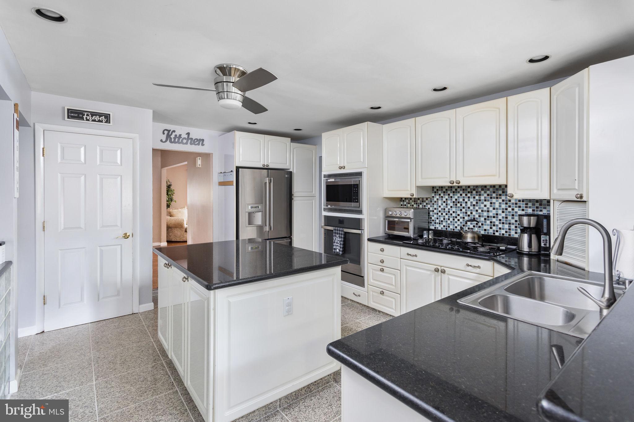 420 Extonville Road Allentown, NJ 08501 - Photo 34 of 57 a kitchen with stainless steel appliances a sink stove and refrigerator