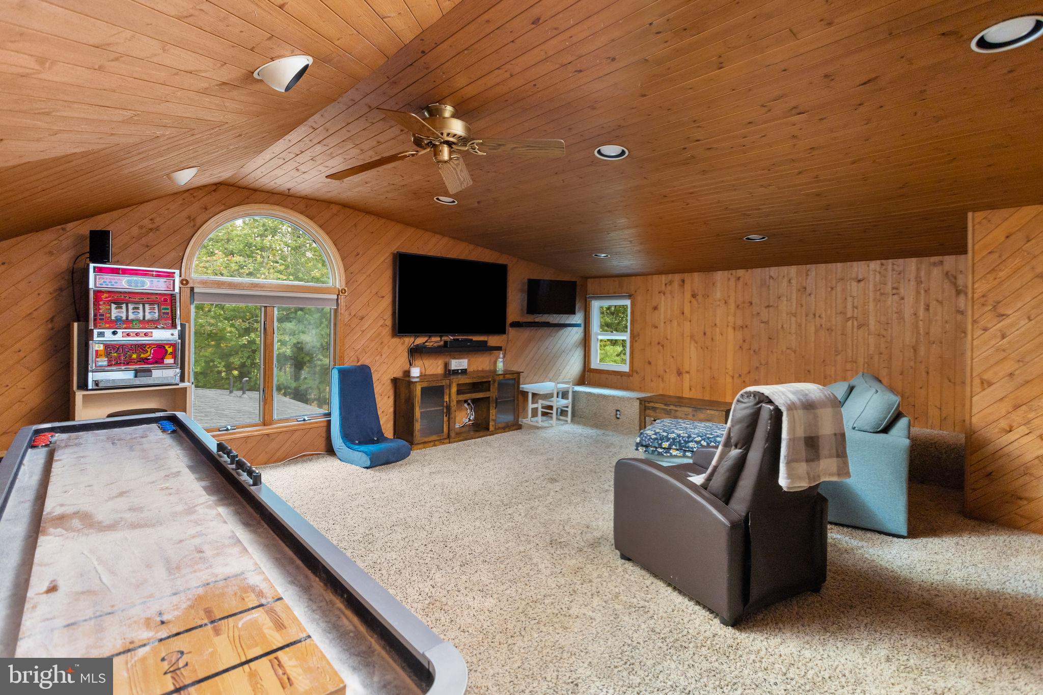 420 Extonville Road Allentown, NJ 08501 - Photo 42 of 57 a living room with furniture a flat screen tv and a large window