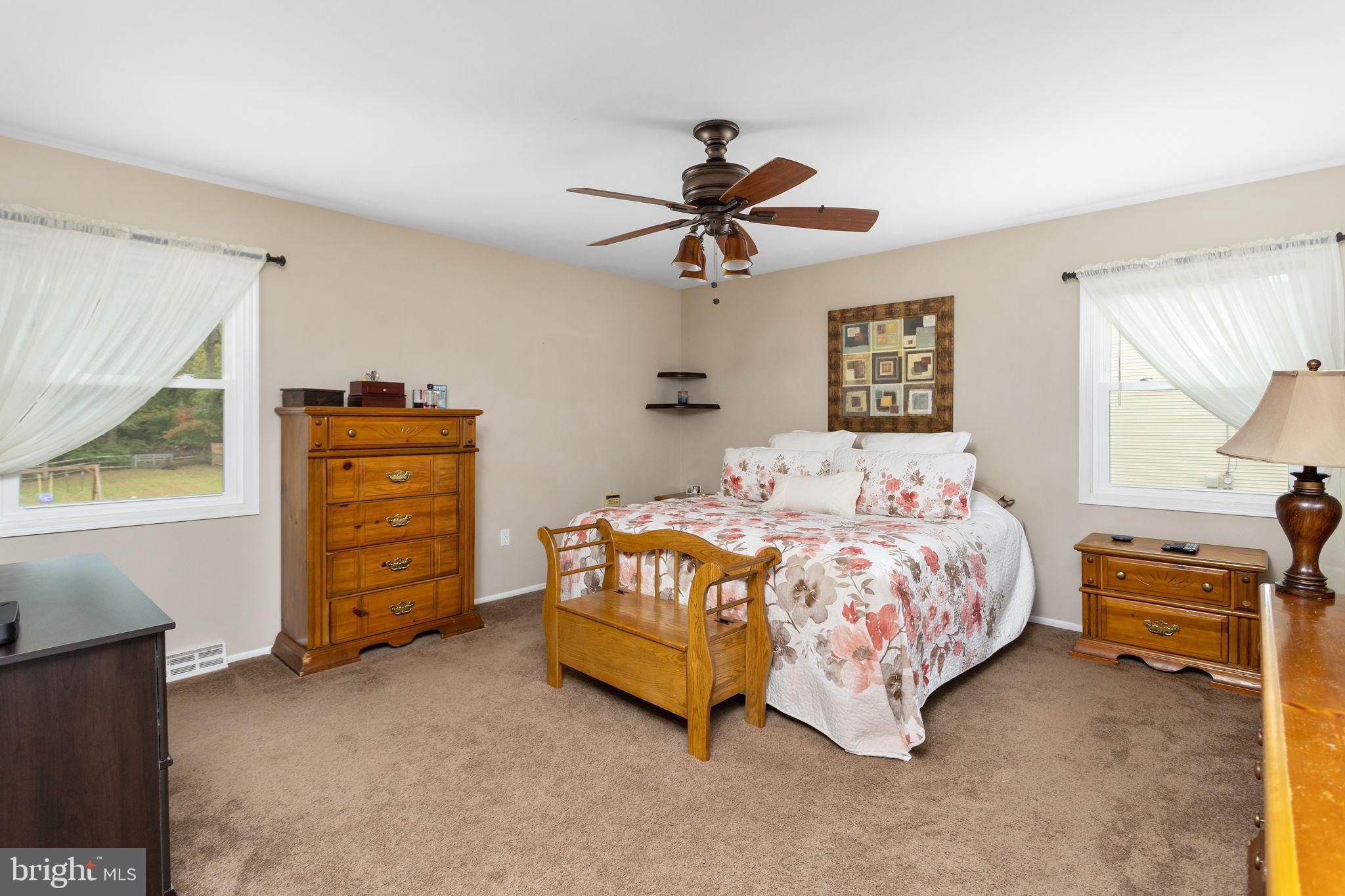 420 Extonville Road Allentown, NJ 08501 - Photo 45 of 57 a bedroom with a bed and a chandelier