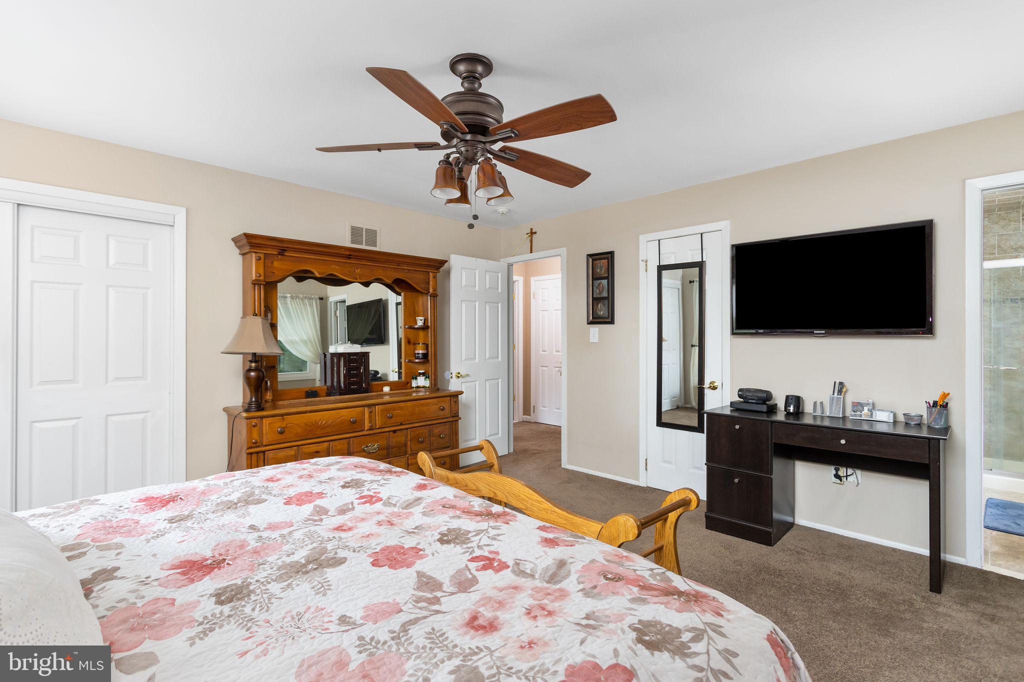 420 Extonville Road Allentown, NJ 08501 - Photo 46 of 57 a bedroom with a bed and a flat screen tv