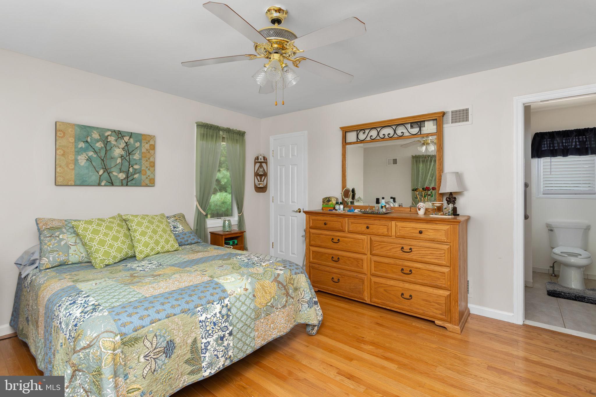 420 Extonville Road Allentown, NJ 08501 - Photo 55 of 57 a bedroom with a bed and a chandelier