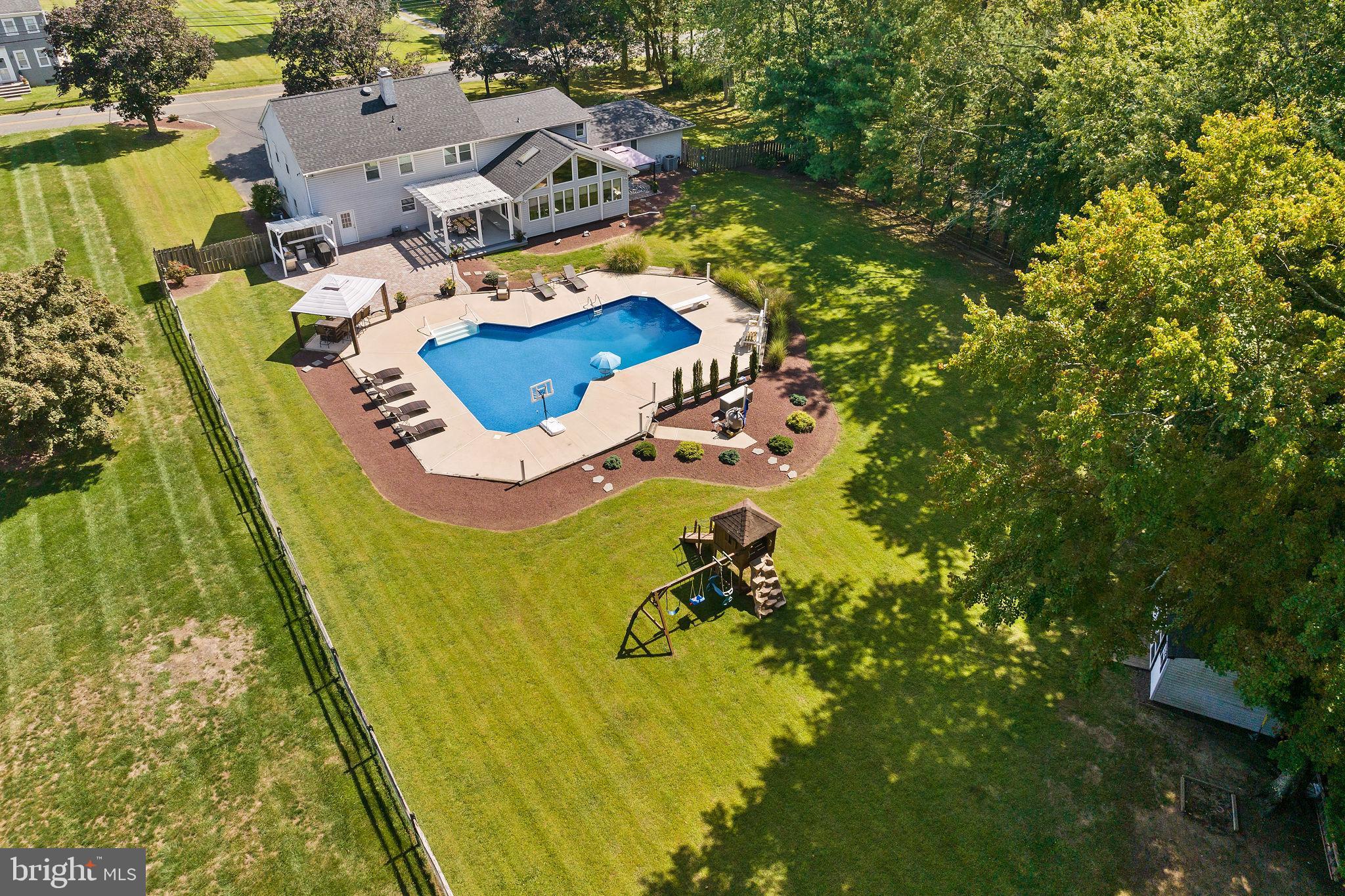 420 Extonville Road Allentown, NJ 08501 - Photo 10 of 57 an aerial view of residential house with swimming pool and lawn chairs