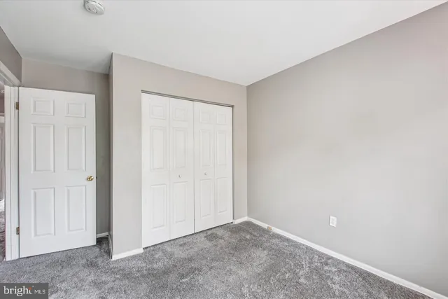 an empty room with closet area