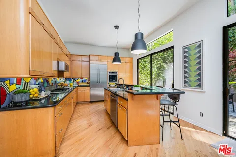 a kitchen with stainless steel appliances granite countertop sink stove top oven and cabinets