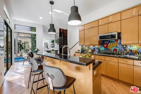 a kitchen with stainless steel appliances granite countertop a sink and a stove