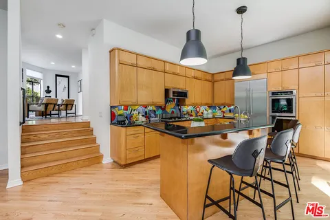 a kitchen with stainless steel appliances granite countertop a stove and cabinets