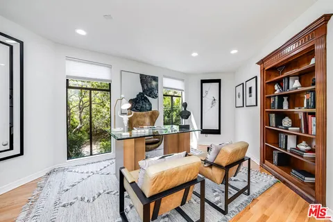 a living room with furniture and a book shelf
