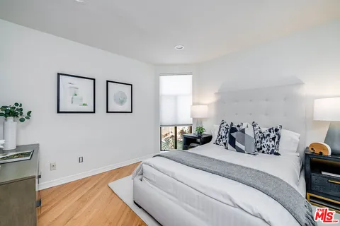 a bed room with a bed and a night stand