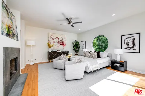 a bed room with furniture and a fireplace