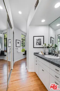 a hall with cabinets and wooden floor
