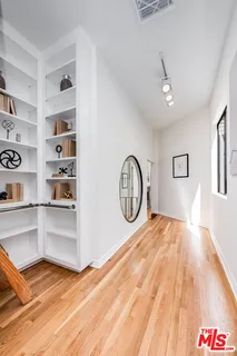 a view of a hallway with wooden floor